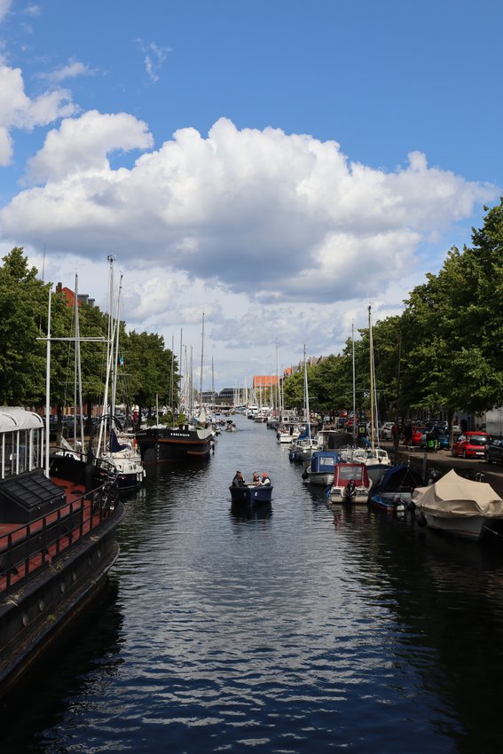 A boat floats down a canal in Copenhagen