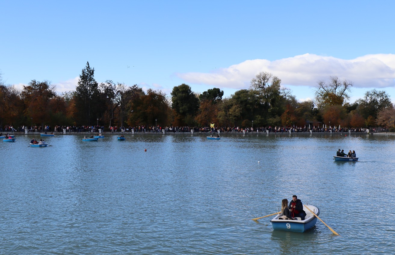 Couples row in boats on an artificial lake