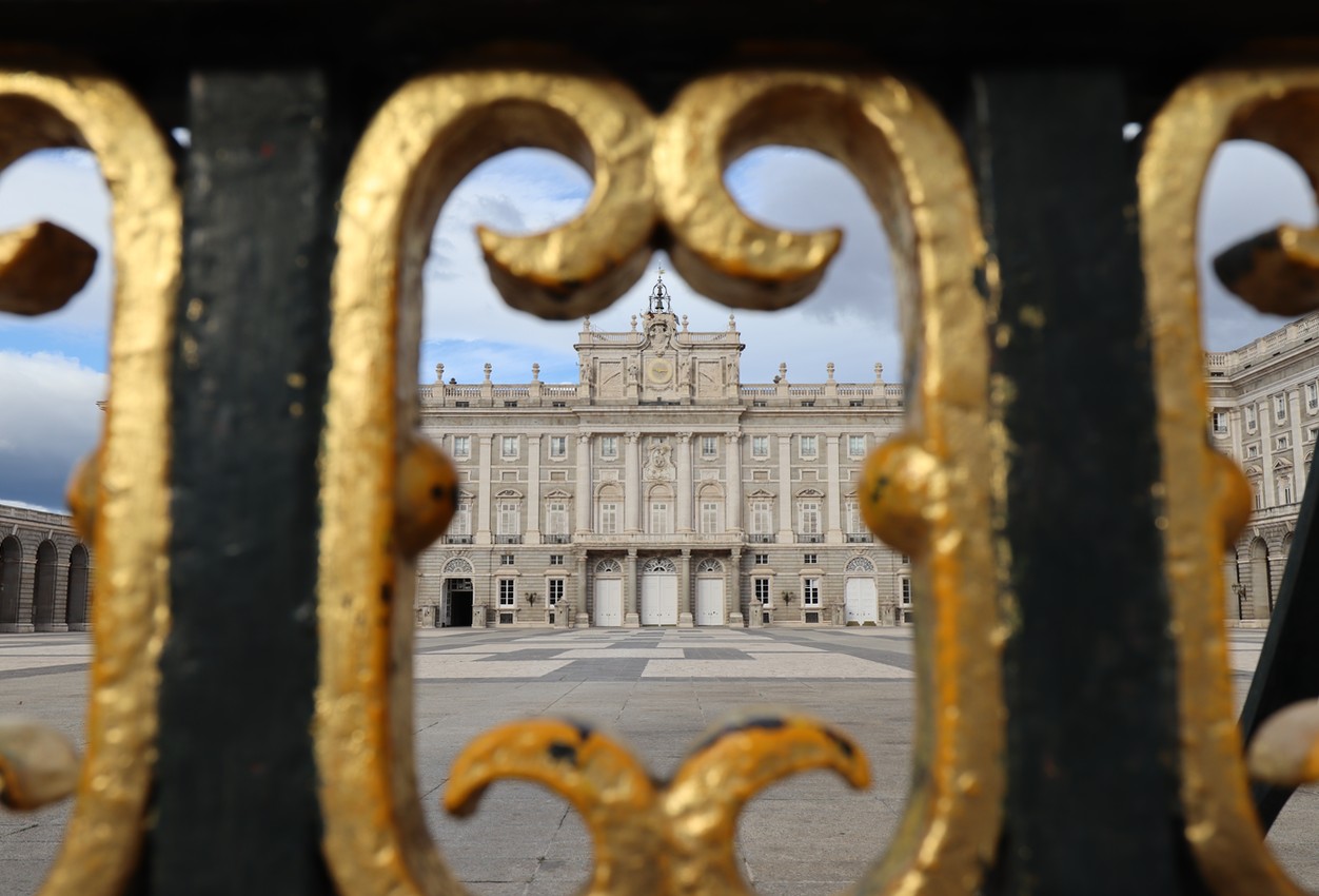 The Royal Palace in Spain, as seen through the bars of a gate