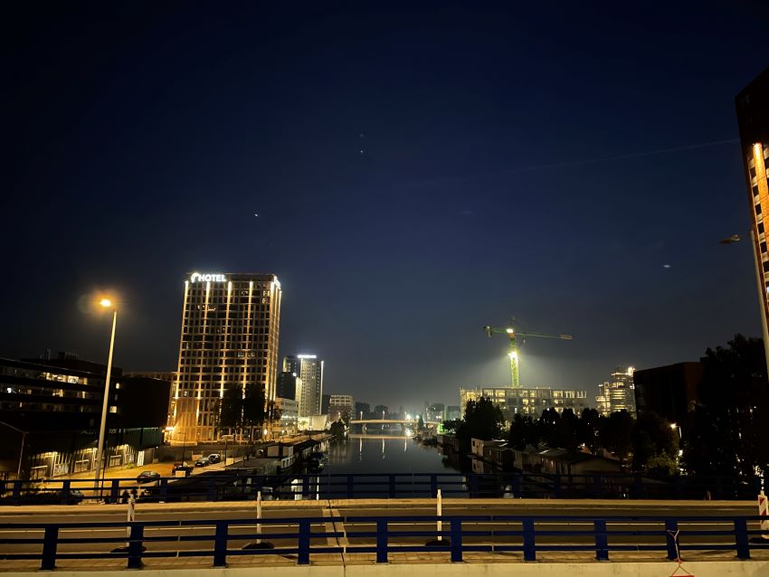 Buildings over the Amstel at night