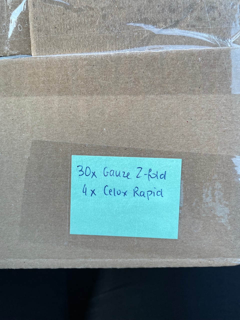 A box with a label indicating its contents: 30x z-fold gauze, 4x Celox bandages